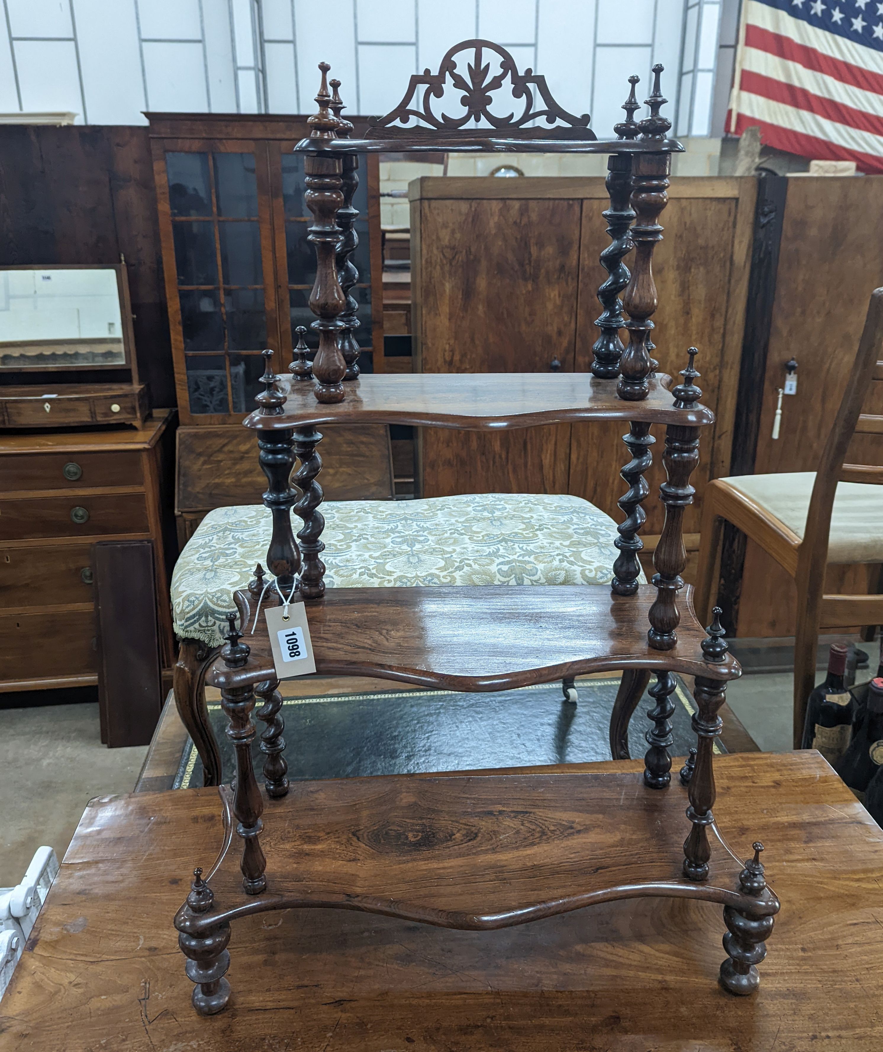 A small Victorian rosewood serpentine fronted four tier whatnot, width 61cm, depth 21cm, height 94cm